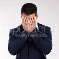 Somebody save me from this misery. Studio shot of a young businessman covering his face against a white background.