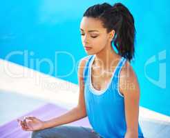 Making time to meditate. Shot of a young woman doing yoga outdoors.