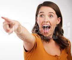 Whos fault was it. Studio shot of a young woman pointing in a direction against a white background.