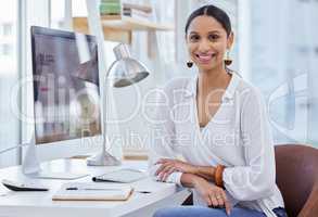 Where others fail youll prevail in time. Portrait of a young businesswoman sitting at a desk in a modern office.