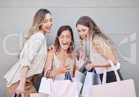 We have to get there now. Cropped shot of three attractive young women taking some time out to enjoy a shopping spree in the city.