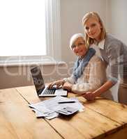 Lending a hand with Grandmas tax returns. A granddaughter helping her grandmother with her budget.