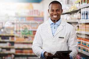 All our aisles are stocked full for your convenience. Portrait of a young pharmacist working in a chemist.