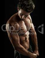 Ripped. Muscular young man showing off his defined body.