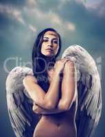 Pure angelic beauty. Shot of a female angel against the sky.