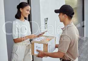 Delivery for you maam. Shot of a young woman signing for an order with a delivery man using a digital tablet.