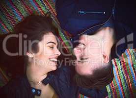 Its a day booked for love. Shot of a happy young couple lying on a blanket outdoors.