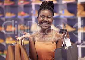 Shopping is a bit of a relaxing hobby for me. Shot of a woman holding bags in a retail shop.