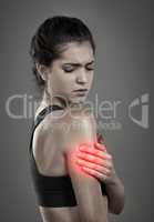 Pain is part of the process. Studio shot of a young attractive woman holding her injured arm that gets shown through CGI.