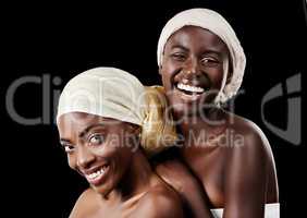 I cant imagine my life without her. Studio portrait of two beautiful women wearing headscarves against a black background.