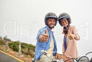 Were ready to hit the road. Shot of an adventurous couple out for a ride on a motorbike.