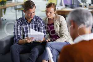 Theyre realizing their dreams - Financial Planning. Smiling young couple receiving positive advice from their financial consultant.