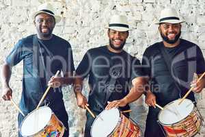 Listen to our Samba sounds. Cropped portrait of a group of handsome young male drummers playing at Carnival.