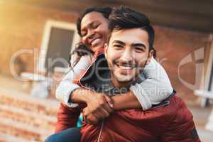 After we graduate Im going to marry her. Portrait of a happy young couple enjoying a piggyback ride on campus.