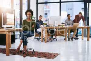 Great leaders are made, not born. Portrait of a confident businesswoman with her team working in the background.