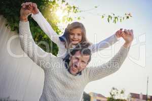 I hope shes never too big for daddy-daughter time. Shot of a happy father and daughter enjoying a piggyback ride in their backyard.
