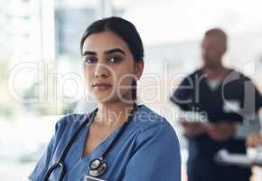 Dr is not just my prefix, Its my superpower. Shot of a young female doctor standing in the office of a hospital.