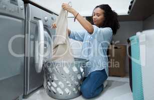 I have a huge load of washing to do today. Shot of a young woman preparing to wash a load of laundry at home.