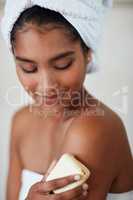 Investing in the health of her skin. Shot of an attractive young woman having a relaxing pampering session at home.