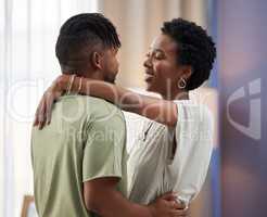 Dance partners for life. Shot of a young couple dancing in the living room at home.