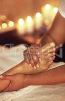 Ease the tightness of a long day. Cropped shot of a woman enjoying a foot massage at a spa.