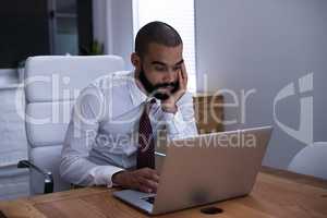 Shot of a businessman working on his laptop late at night. Real life businesspeople shot on location. Since these locations are the real thing, and not shot in an office studio, high ISO levels are sometimes needed to catch the moment. The ISO range is be