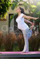 Yoga lite.... Shot of a young pregnant woman doing yoga outside.