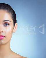 Crystal clear skin. Studio portrait of a beautiful young woman posing against a blue background.