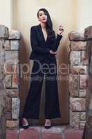 Structured fashion. Full length shot of a woman wearing a classic feminine suit.