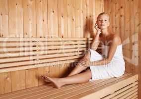 This is her bliss. A gorgeous blond woman relaxing in a sauna.