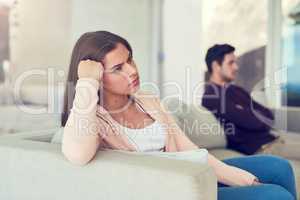 Becoming disconnected. Portrait of a young woman giving her husband the silent treatment after a fight.