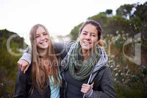 We love hiking on weekends. Portrait of two attractive young female hikers in the outdoors.