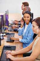 Were always online. Shot of customer service representatives in a call center.