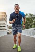 Getting more fit by the day. Shot of a young man out for a run in the city.