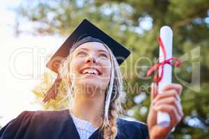 I have something to show off for all the struggle. Cropped shot of a happy young woman holding her certificate on graduation day.