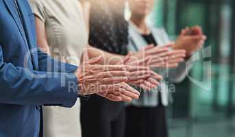 That was an outstanding job. Cropped shot of a group of unrecognisable businesspeople applauding together in an office.