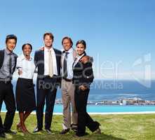 Building bonds by the pool. Shot of business people standing together in front of an oceanside pool.