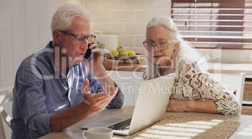 Theres an added charge I dont recognise. Shot of a senior couple sitting together in their kitchen at home and calculating their finances.