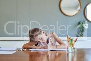 Shes a diligent student at school and at home. Shot of a little girl doing her homework.