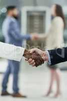 Collaborative spirits. Cropped shot of two unrecognizable businesspeople shaking hands in a corporate office.