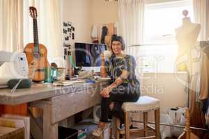 Surrounded by her creative endeavors. Portrait of a stylish young designer sitting in her eclectic studio.