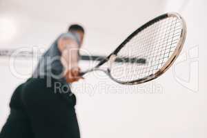 How you grip it determines whether youll win it. Low angle shot of a man playing a game of squash.