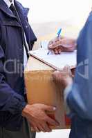 Delivering direct to your door. A friendly delivery man delivering a package to a home.