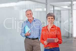 Theyre bringing expert experience to their business. Two mature coworkers standing together in the office.