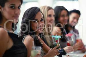 Girls just want to have fun. Portrait of a group of girlfriends enjoying cocktails together on a night out.