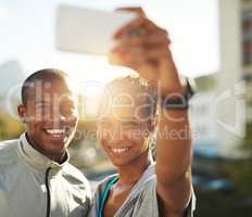 Vibrant with vitality. Shot of a young sporty couple taking a photo together with a cellphone.