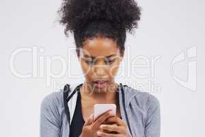 Does banking online scare you. Studio shot of a young woman looking surprised while reading something on her cellphone.