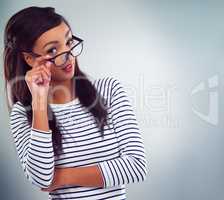 Excuse me. Studio shot of a young woman posing against a grey background.