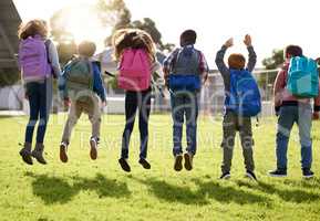 Jump for joy, its holiday. Shot of young kids playing together outdoors.