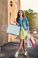 Filling up my closet. Shot of a beautiful young woman on a shopping spree in the city.